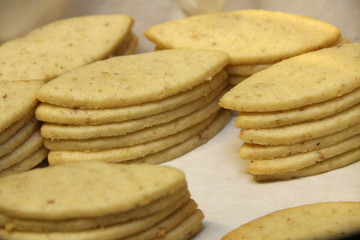 Stacked shortbread biscuits lie on white paper