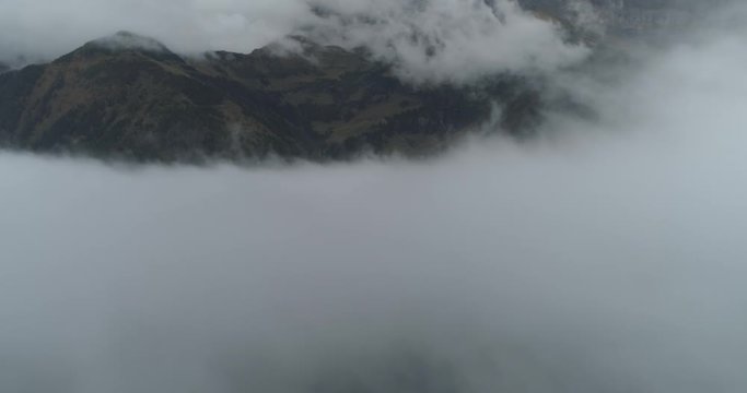 Flying over cloud in swiss montain in autumn