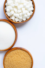 Wooden bowl with sugar on white background.