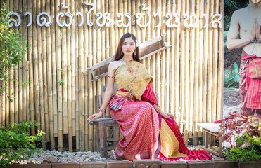 Fototapeta premium Beautiful woman, Thai national costume, traditional Thai dress, Thai woman, good mood, beautiful smile background - Image with noise and grain