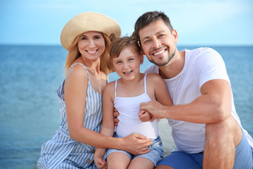 Portrait of happy family on sea beach