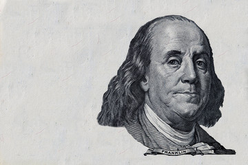 Fototapeta na wymiar Benjamin Franklin cut on old 100 dollars banknote isolated on white background
