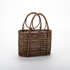 rattan wicker bag with handles openwork weaving in studio photography