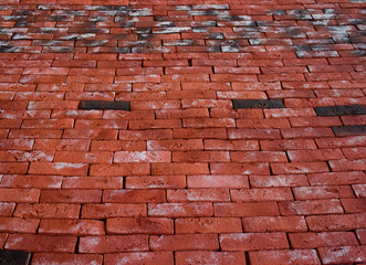 A wall of red plaster bricks