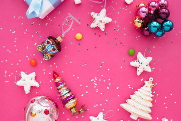 Christmas composition. Beautiful toys, gifts and candy on the pink background. New year background. Top view. Close up. Space for a text.