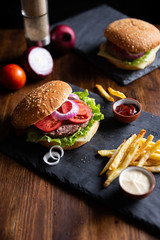 open burger with onions and sauces, vertical