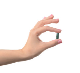 Female hand with pill on white background