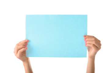 Obraz premium Female hands with empty sheet of paper on white background