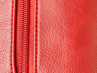 Red leather background with red zipper, copy space