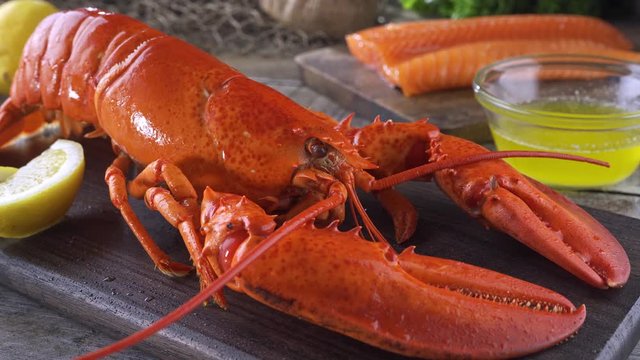 A delicious cooked lobster on a rustic table top.