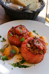 Greek Stuffed Tomatoes,  Gemista filled with rice, chopped vegetables and baked in a tomato sauce and basked of bread. Taken in Donoussa Island, Greece