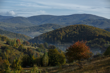 Fototapeta na wymiar autumn mountains with haze of rising clouds