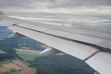 An airplane window view of wing and flaps 