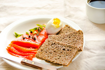 Salted red fish salmon with quail eggs, avocado and buckwheat gluten-free bread. Rustic. Products with omega-3 good for healthy hair and skin