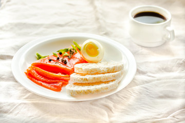 Slices of Salted Raw fish fillet with egg and rice cakes. Selection of good fat sources - healthy eating concept. Ketogenic diet concept. Selective focus