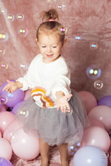 little girl with balloons and bubbles