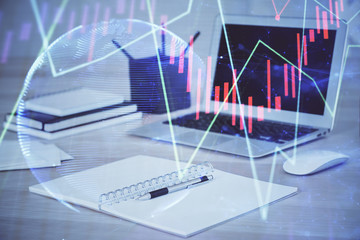 Stock market chart hologram drawn on personal computer background. Double exposure. Concept of investment.