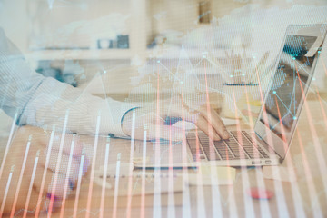 Multi exposure of stock market graph with man working on laptop on background. Concept of financial analysis.