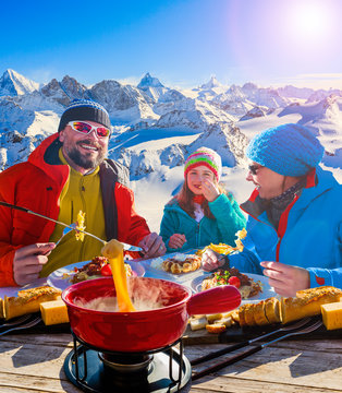 Fondue cheese, swiss winter ski holidays break for lunch, mountain view Matterhorn in Zermatt, Switzerland.