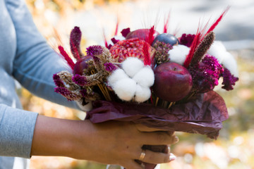 Beautiful fruit bouquet of apples, pomegranates, flowers, cotton.