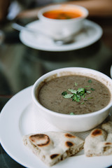 Lentil soup in white bowl in the cafe 