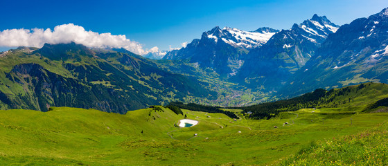 Fototapeta na wymiar Panorama of Wetterhorn massif raised above the valley settlements of Grindelwald as seen from Klein Matterhorn, Switzerland