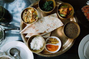 Nepali vegetarian set. Buckwheat bread, vegetable curry, beans and paneer cheese
