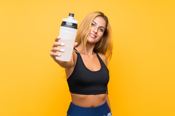 Young sport woman with a bottle of water over isolated background