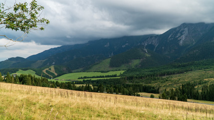 Valley in mountains. Sky in clouds.