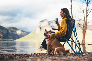 tourist traveler girl think relax drink tea together dog on background mountain, puppy pet woman...