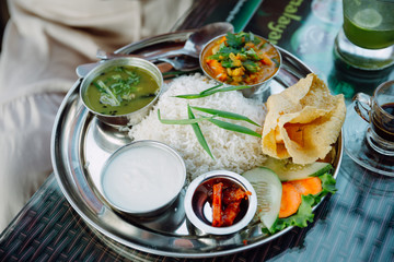 Set of vegetarian plates with Nepalese and Indian style food. Different types of curry