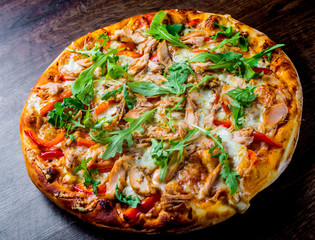 Pizza with Mozzarella cheese, salmon fish, tomato sauce, pepper. Italian pizza on wooden table background