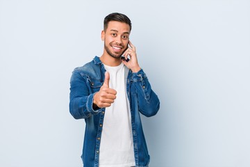Young south-asian man holding a phone