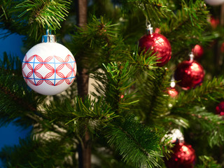 Fototapeta na wymiar Christmas tree decorated with festive balls. Close up of christmas decoration on christmas tree