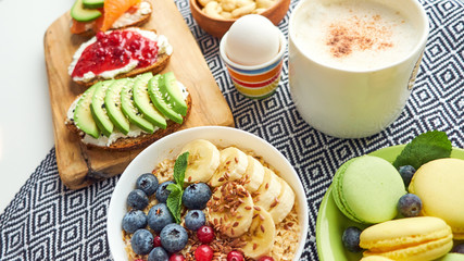 breakfast top view isolate white background. oatmeal with berries, toasts on a wooden tray, nuts, coffee