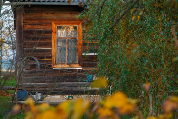 Window and part of an old rural house. Country life in an old wooden house