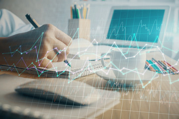 Financial chart drawn over hands taking notes background. Concept of research. Double exposure
