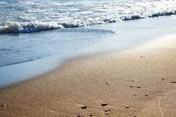 Soft wave of the sea on the sandy beach. pure transparent waves beat on the sandy shore.