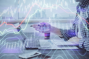 Double exposure of stock market chart with man working on computer on background. Concept of financial analysis.