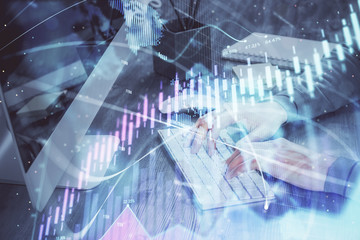 Double exposure of financial graph with man works in office on background. Concept of analysis.
