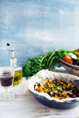 Roasted vegetables pieces (tomato, aubergine, pepper), top view over a rusty white wooden background