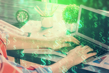 Double exposure of stock graph with businessman typing on computer in office on background. Concept of hard work.