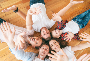 Group of happy people. A couple with a child and their friends. Shot from above. Community...