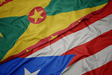 waving colorful flag of puerto rico and national flag of grenada.