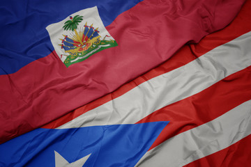 Fototapeta premium waving colorful flag of puerto rico and national flag of haiti.