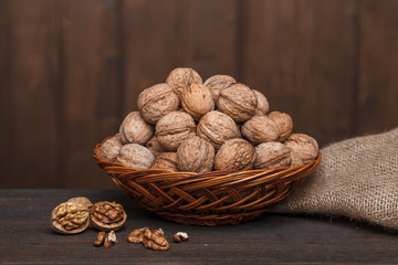 walnuts in a basket on a wooden table