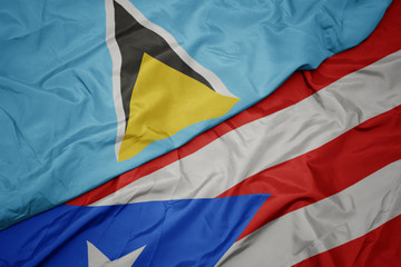 waving colorful flag of puerto rico and national flag of saint lucia.