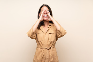 Young girl over isolated background shouting and announcing something