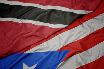 waving colorful flag of puerto rico and national flag of trinidad and tobago.