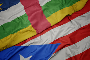 waving colorful flag of puerto rico and national flag of central african republic.
